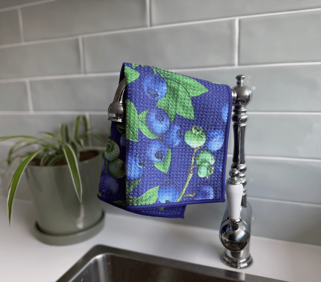 DirtyGirl Berry Fresh Cloth draped over sink tap – Absorbent weave for spills