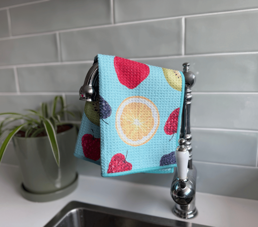 DirtyGirl Tutti Frutti Cloth draped over sink tap – Absorbent weave for spills